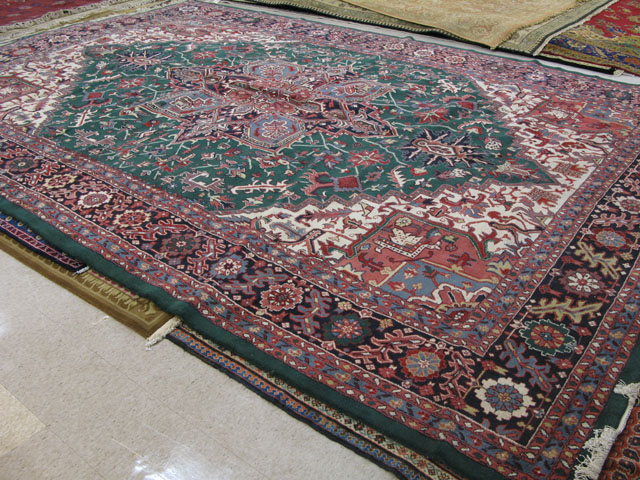 Appraisal: LARGE INDO-HERIZ CARPET centering a large geometric medallion on floral