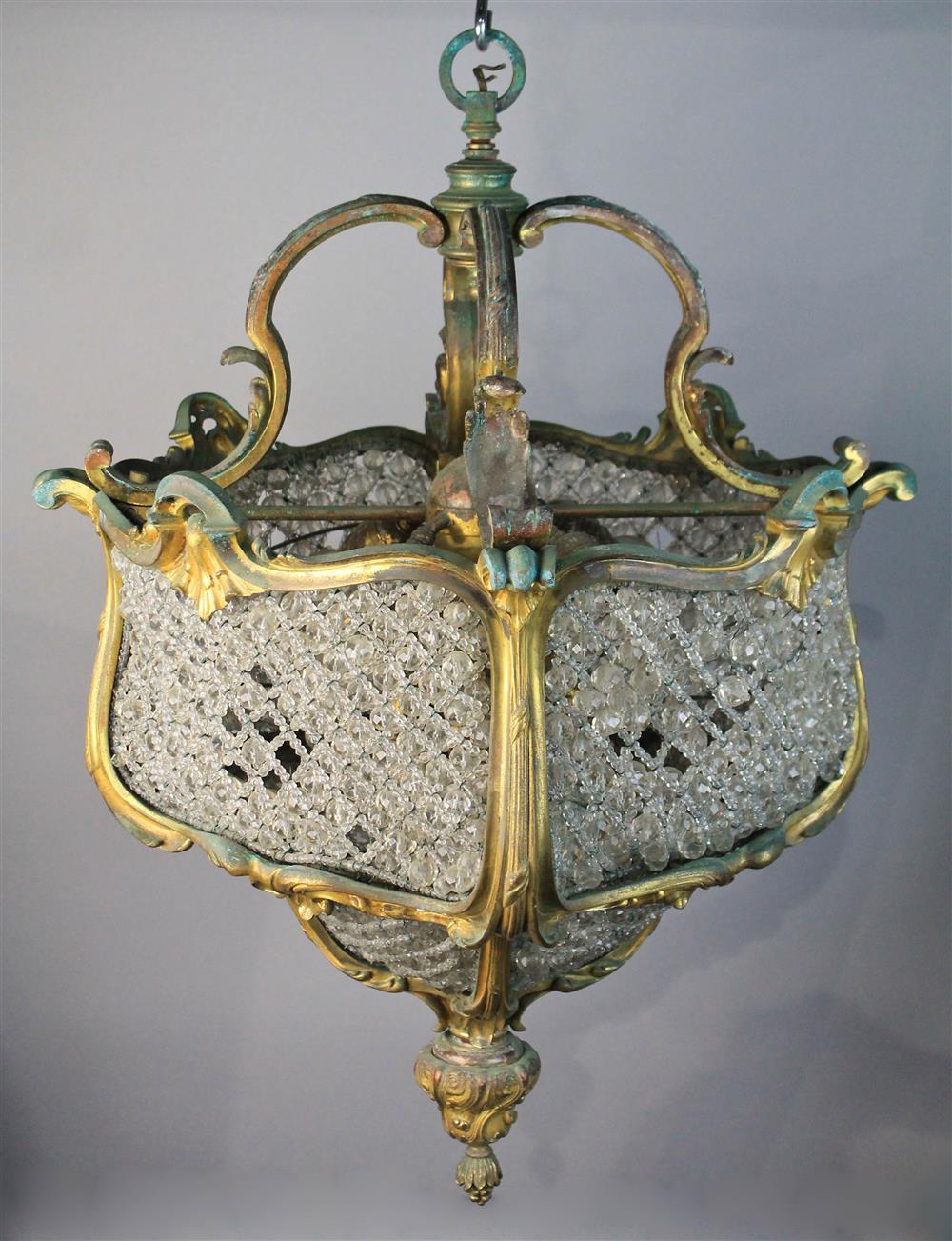 Appraisal: ROCOCO-STYLE GILT METAL CHANDELIER formed of entwined beaded chains supported