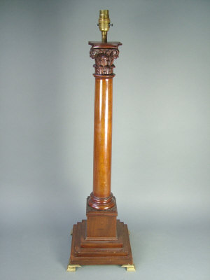 Appraisal: A mahogany corinthian column table lamp the stepped base with