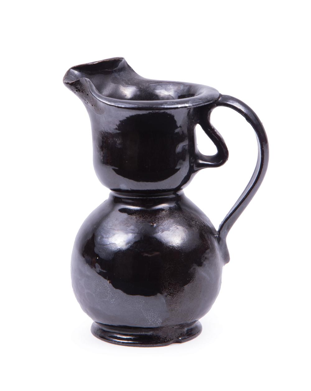 Appraisal: George Ohr Art Pottery Cream Pitcher ribbon handle glossy black