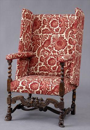 Appraisal: FLEMISH BAROQUE-STYLE CARVED WALNUT WING ARMCHAIR With upholstered back wings