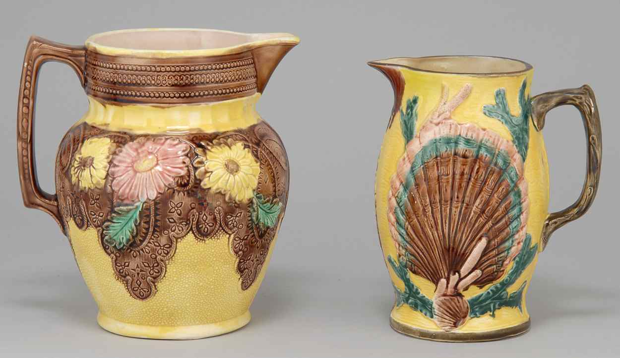 Appraisal: TWO MAJOLICA PITCHERS One with relief shell and coral decoration