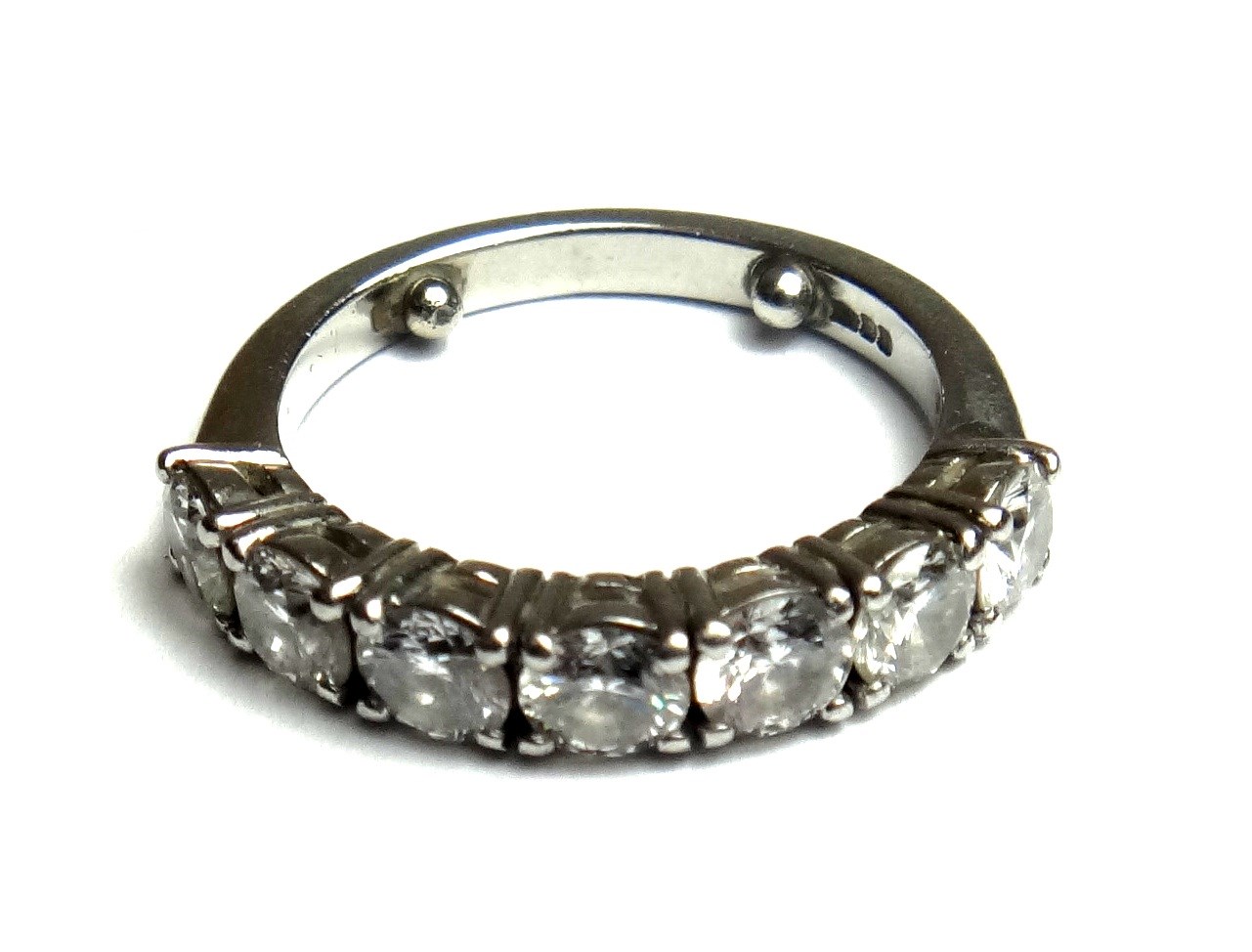 Appraisal: A diamond set seven stone half hoop ring claw set