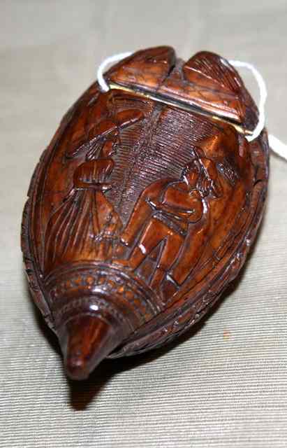 Appraisal: A CARVED WOODEN SNUFF MULL carved in the form of