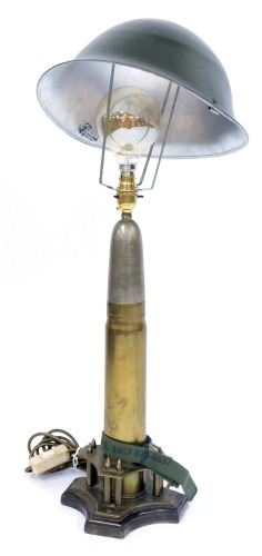 Appraisal: A military style table lamp comprising a shell case converted