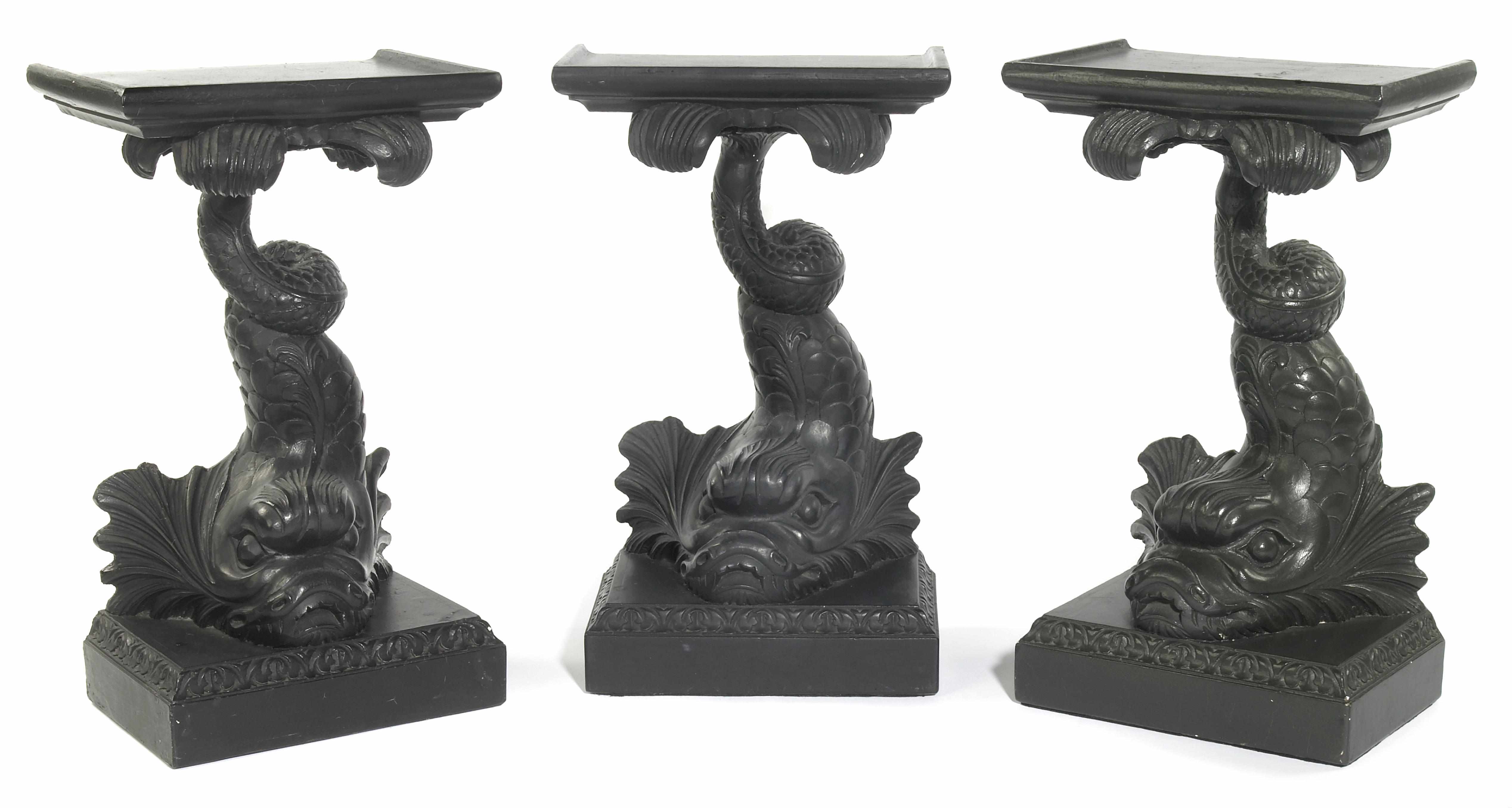 Appraisal: A group of three black painted plaster dolphin form pedestals