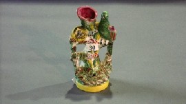 Appraisal: A Staffordshire spill vase of a parrot and nest of