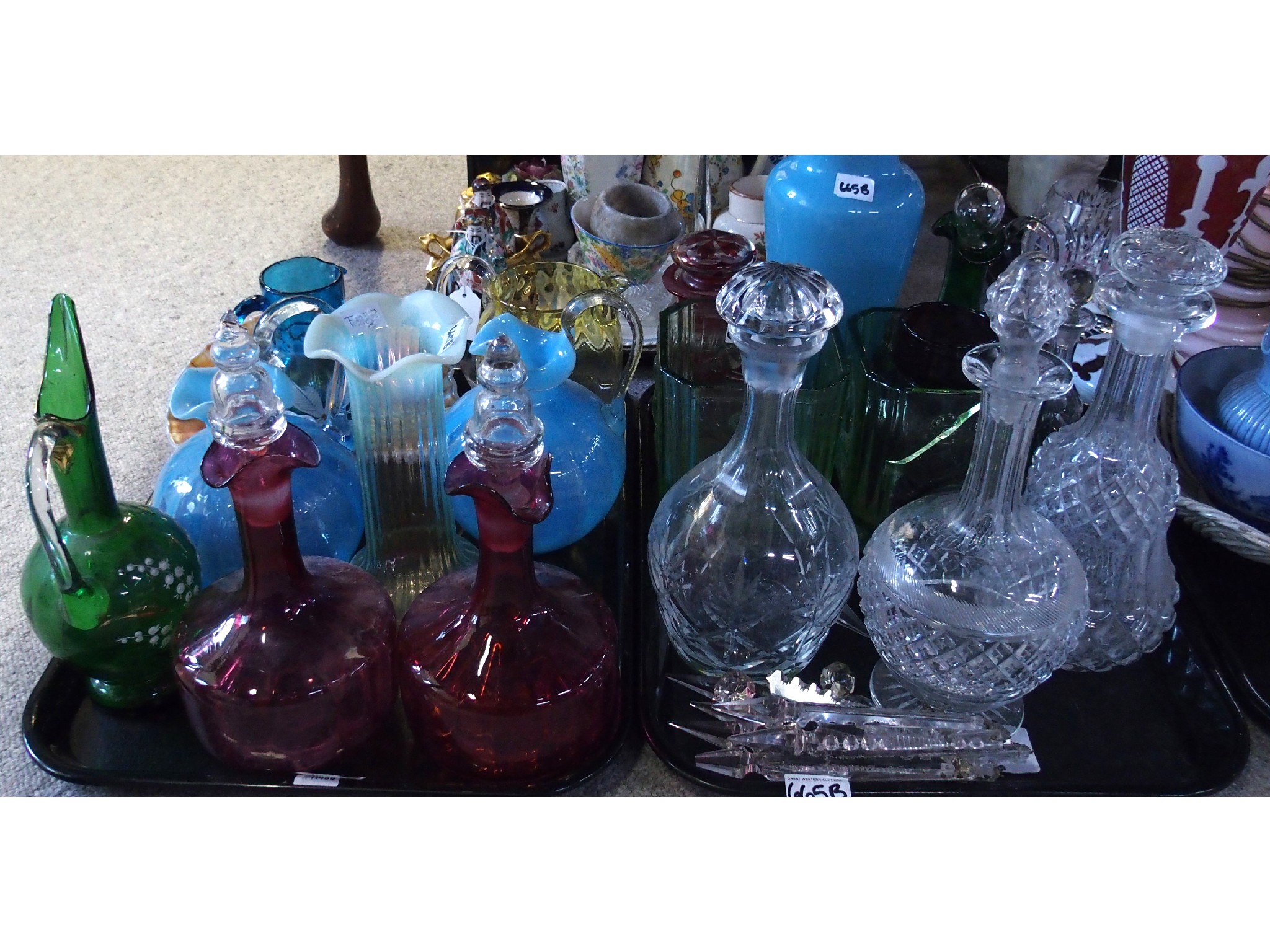 Appraisal: Two trays comprising various coloured glass vessels including decanters vases