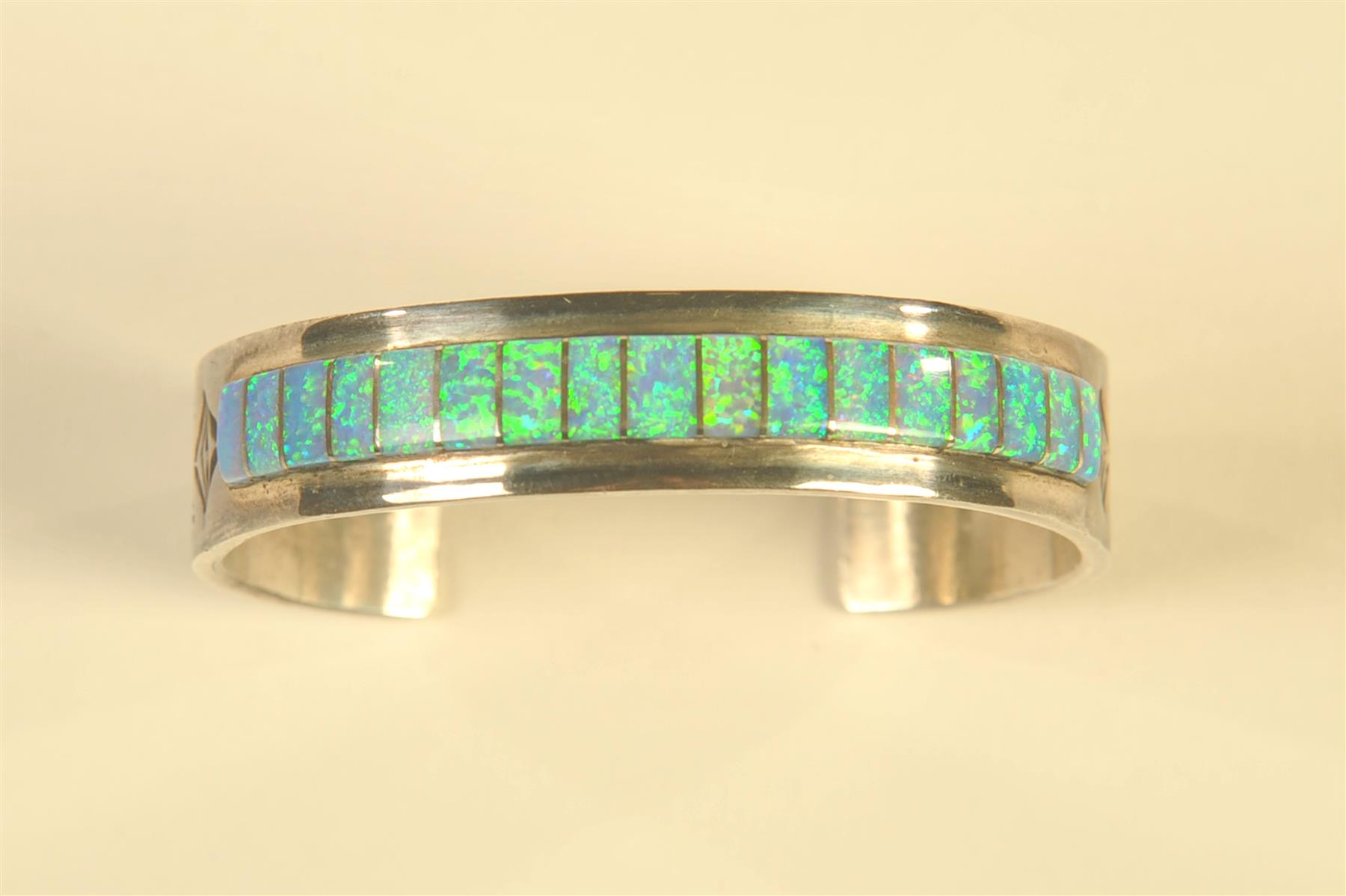 Appraisal: STERLING OPAL INLAY BRACELET American th century Hand tooled silver