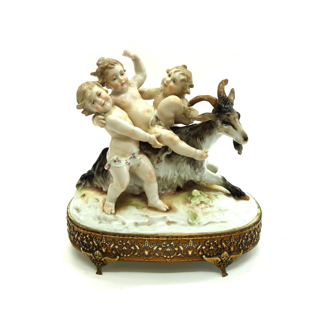 Appraisal: A German porcelain group circa modelled as three putti on