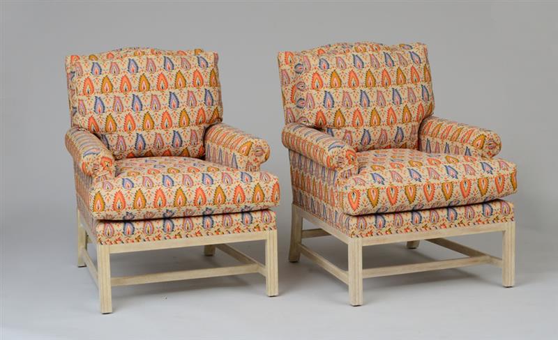 Appraisal: PAIR OF UPHOLSTERED CLUB CHAIRS Together with a matching ottoman