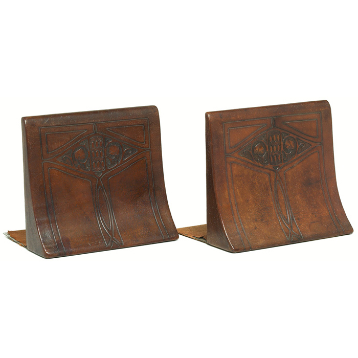 Appraisal: Unusual Roycroft bookends pair leather-wrapped forms with intricately tooled designs