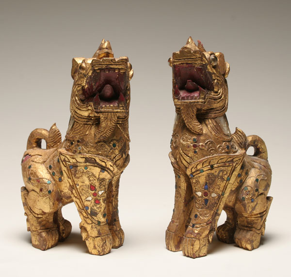 Appraisal: Pair carved foo dogs gilt wood with glass eyes and