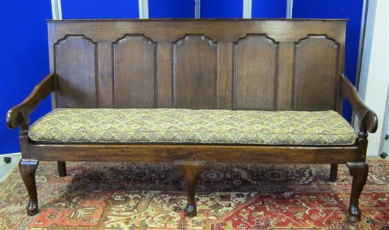 Appraisal: A th century oak panelled back settle with scroll arms