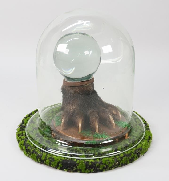 Appraisal: FOUND OBJECT ART BEAR PAW TAXIDERMY CRYSTAL BALLFound object art