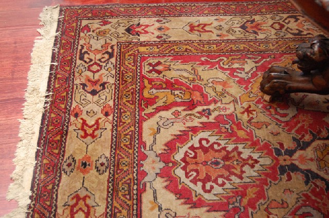 Appraisal: A PERSIAN FLOOR RUG With a geometric field in tones