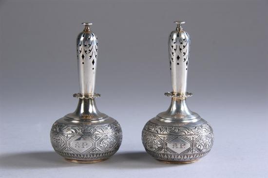 Appraisal: PAIR VICTORIAN SILVER CASTERS George Fox London Bottle form intricately