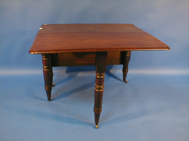 Appraisal: A Victorian mahogany drop leaf table with turned legs