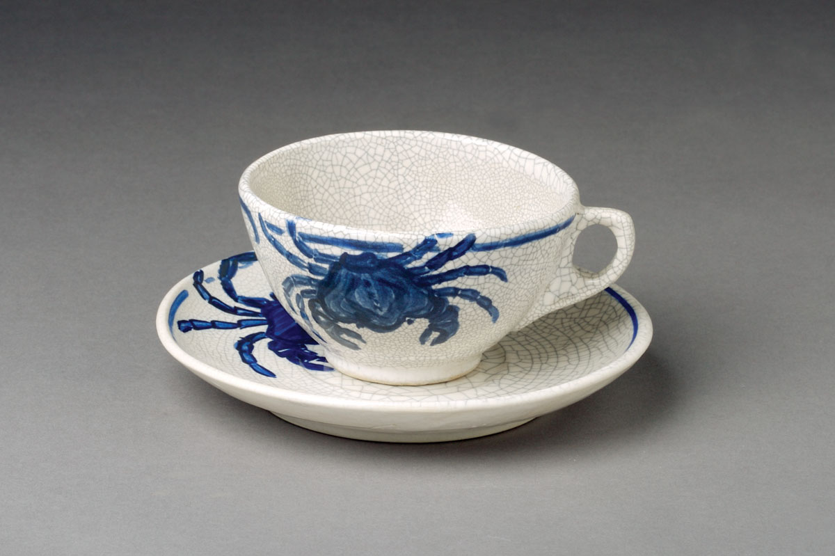 Appraisal: DEDHAM POTTERY 'CRAB' PATTERN TEACUP AND SAUCER Each painted asymmetrically