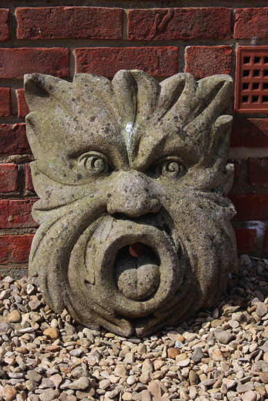 Appraisal: A CARVED AND LIMESTONE WALL HANGING FOUNTAIN HEAD in the