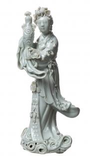 Appraisal: A BLANC-DE-CHINE FIGURE OF A DEITY SCATTERING FLOWERS the deity