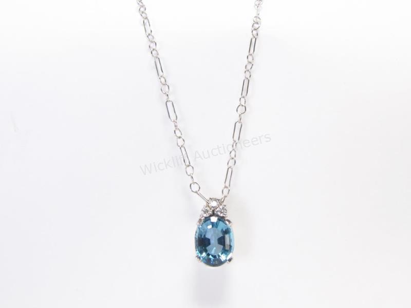 Appraisal: An K white gold pendant with oval Swiss blue topaz