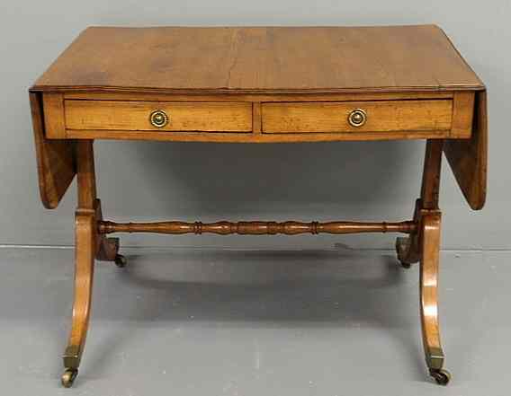 Appraisal: Regency yew wood library table with two drawers and down-swept