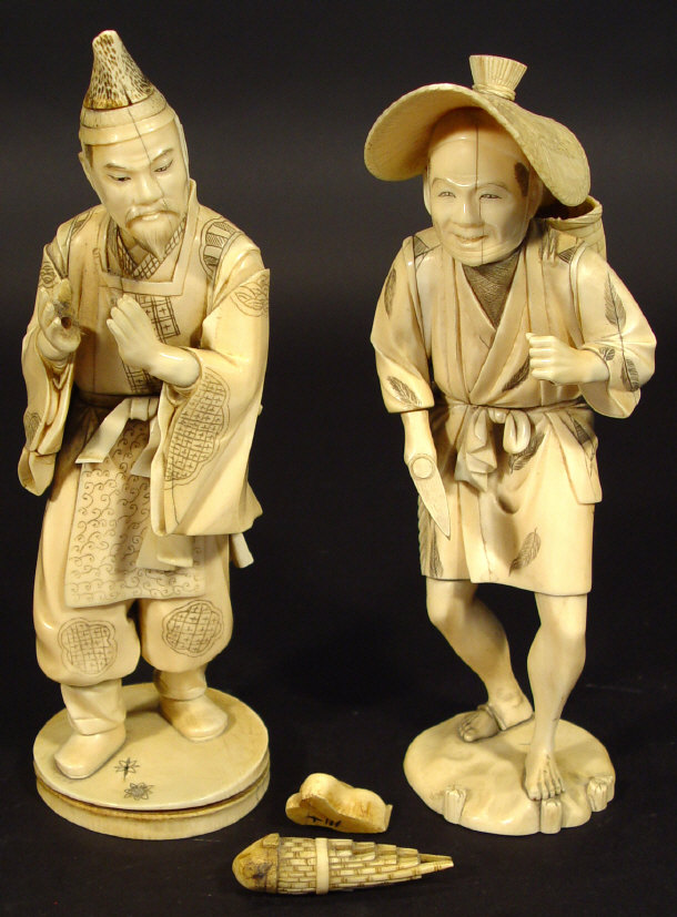 Appraisal: Pair of large oriental ivory figures clutching objects each with