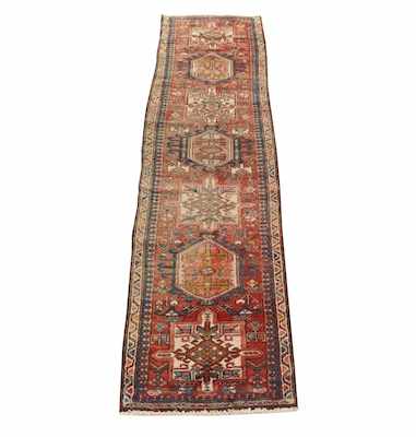 Appraisal: An Antique Heriz Runner Softly aged colors reds blues ivory