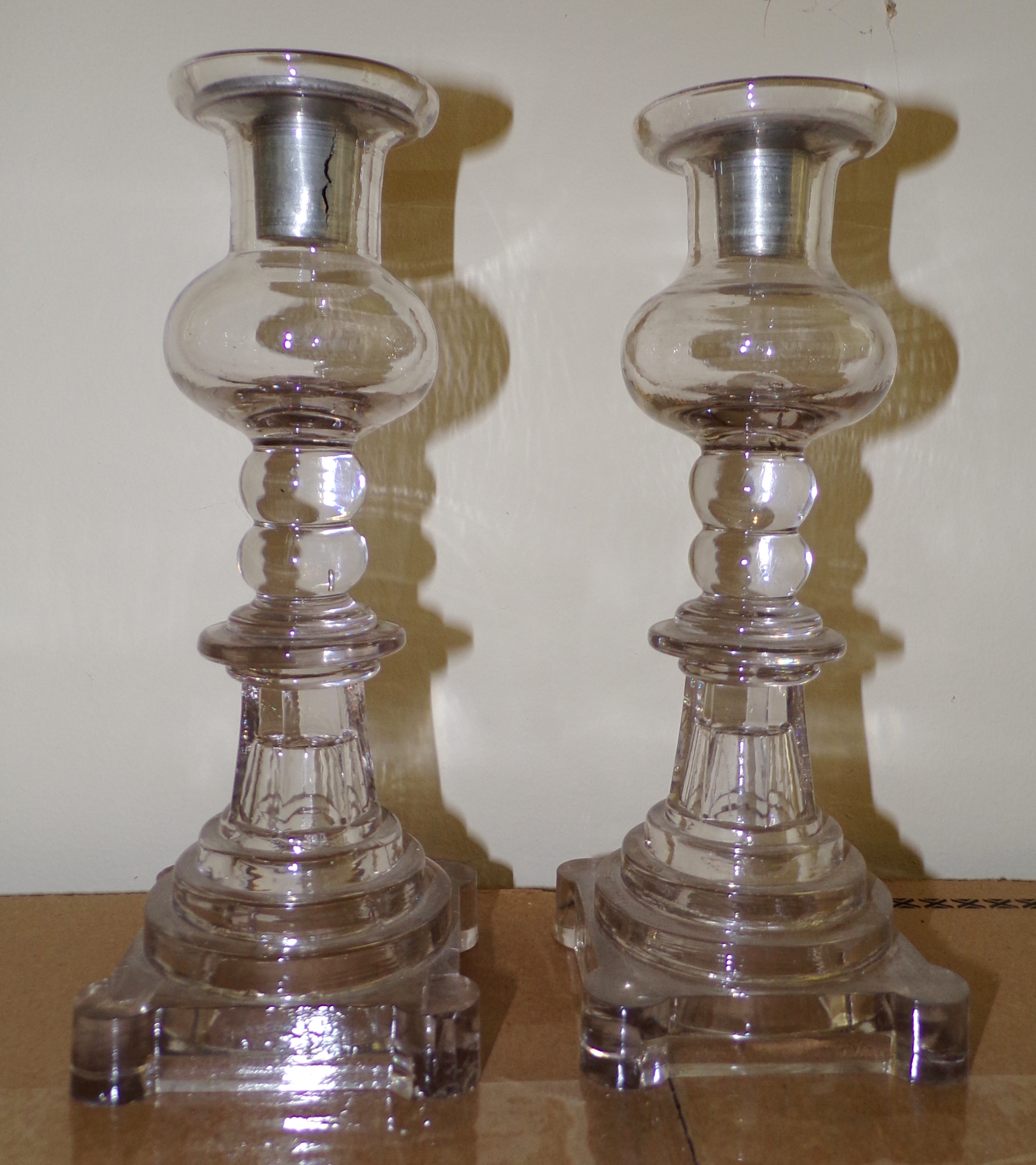 Appraisal: Pair of Flint glass candlesticks with original pewter ca some