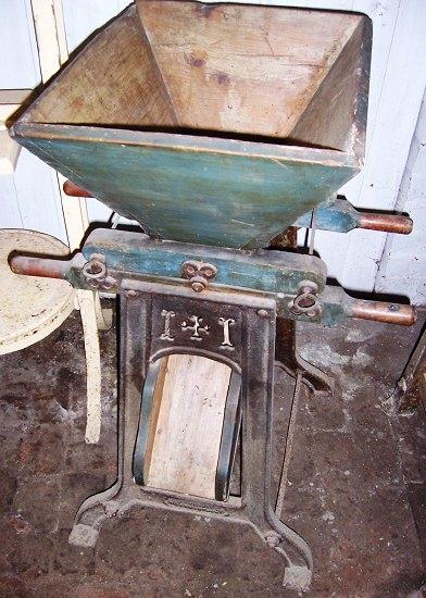 Appraisal: A hand operated curd cutting machine the wooden hopper on