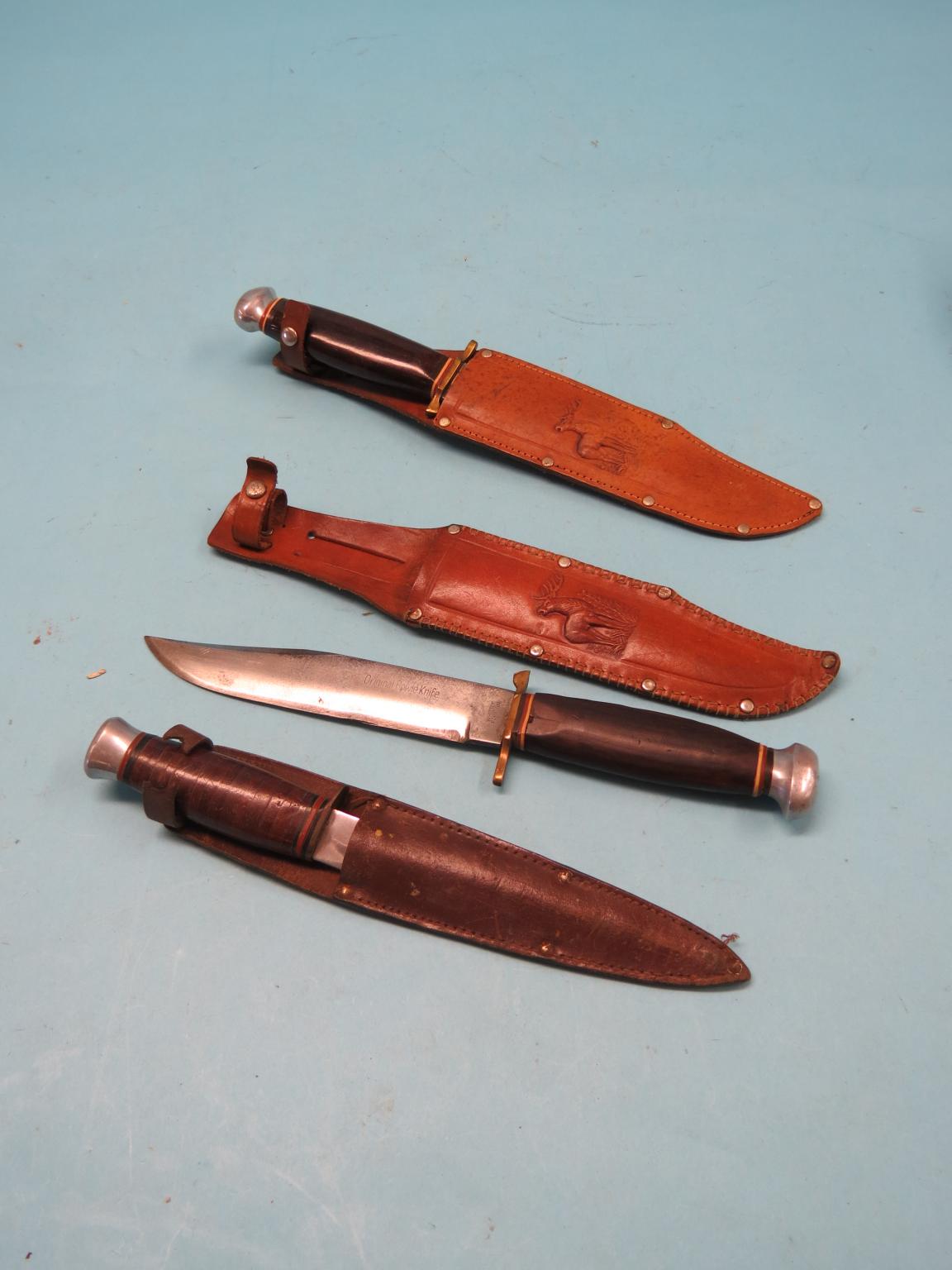 Appraisal: Three Bowie knives each with wood handle in leather sheath