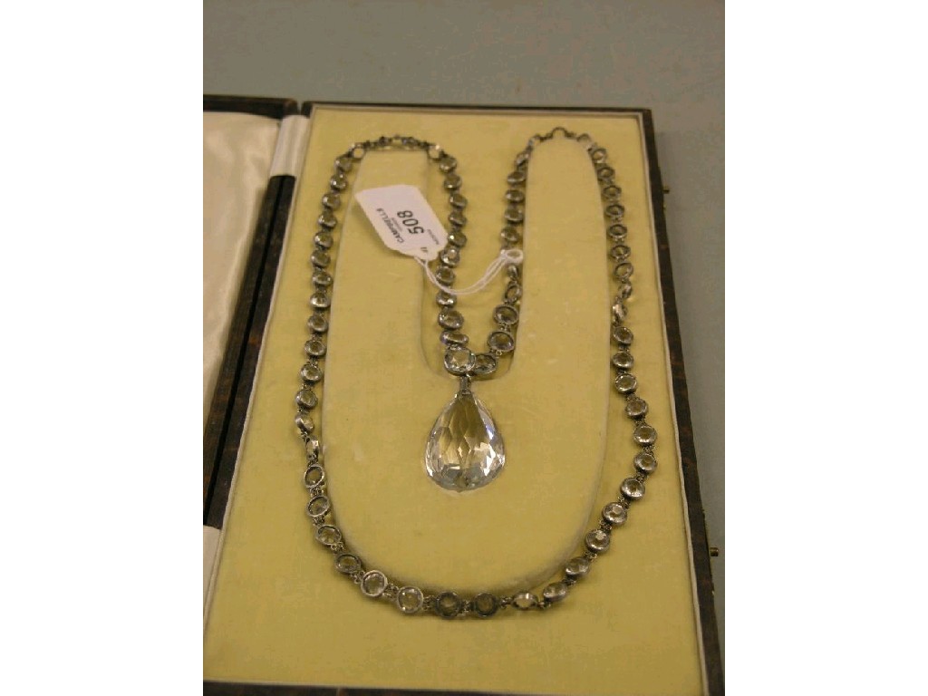 Appraisal: A tear-drop pendant on chain set numerous stones cased