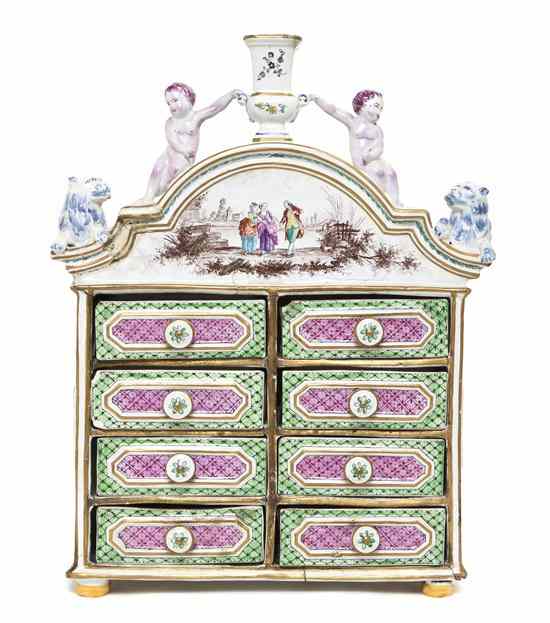 Appraisal: A French Faience Diminutive Chest of Drawers having an urn