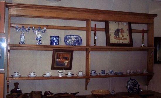 Appraisal: A pine spit rack with moulded cornice fitted shelves and