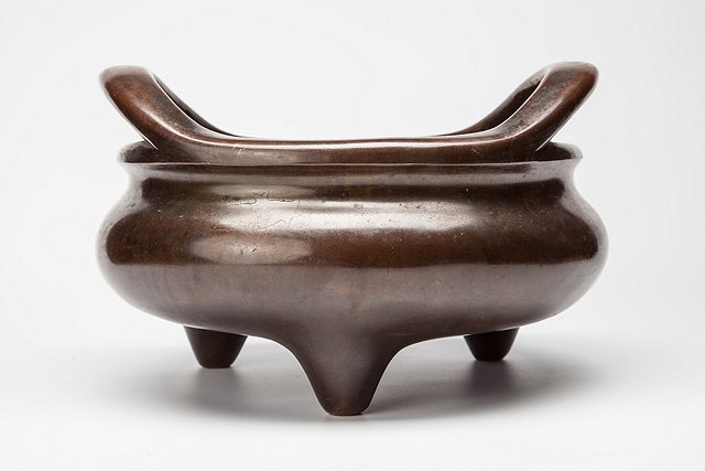 Appraisal: A CHINESE BRONZE TRIPOD INCENSE BURNER the compressed globular body