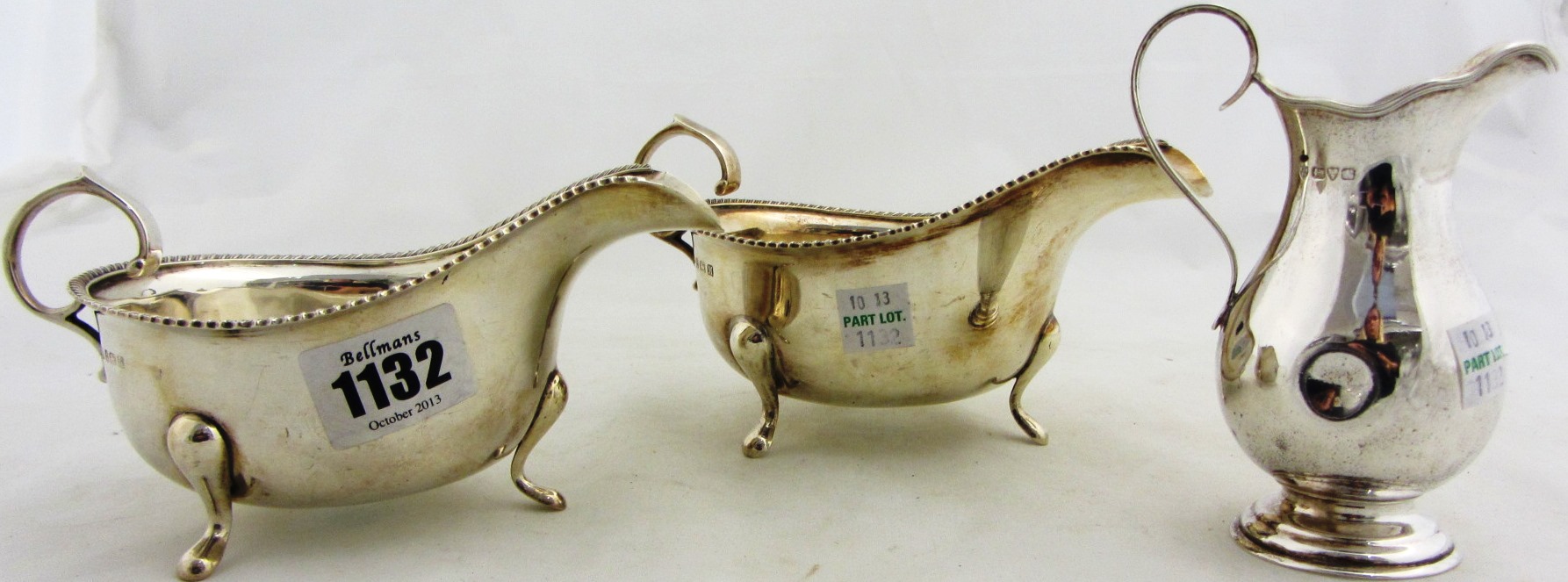 Appraisal: Two similar silver sauceboats each decorated with a gadrooned rim