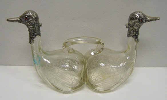 Appraisal: GERMAN SILVER AND GLASS DOUBLE-DUCK DECANTER Glass duck-form bodies with