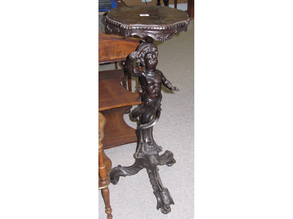 Appraisal: Ebonised torchere on ornate figural tripod base