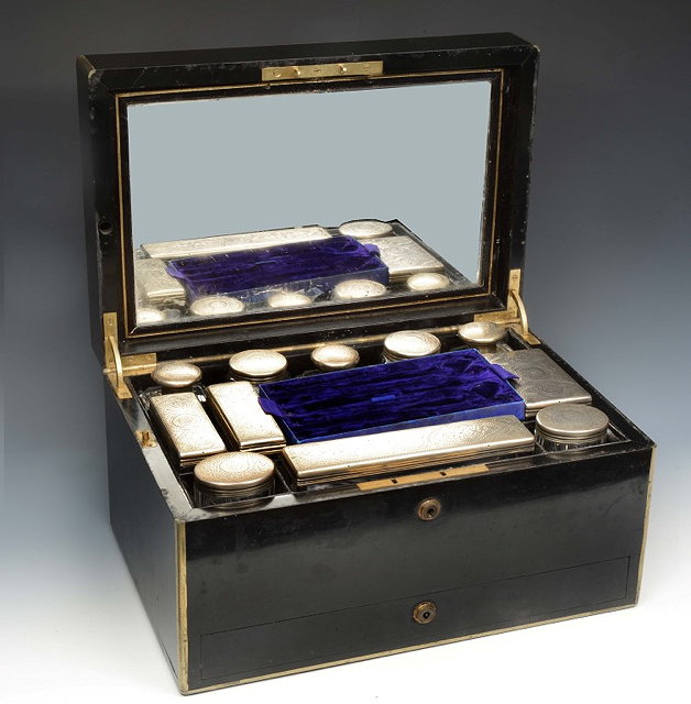 Appraisal: A VICTORIAN LADY'S EBONISED AND BRASS BOUND TRAVELLING DRESSING CASE