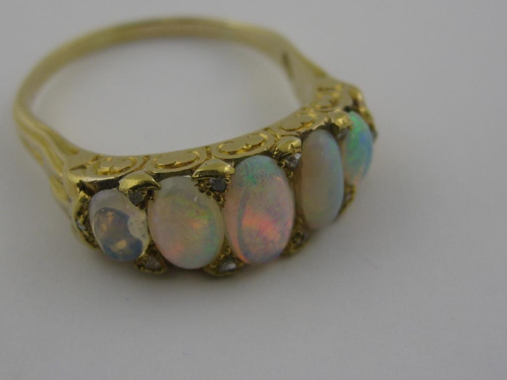 Appraisal: An Opal five stone Ring the graduated oval cabochons pav