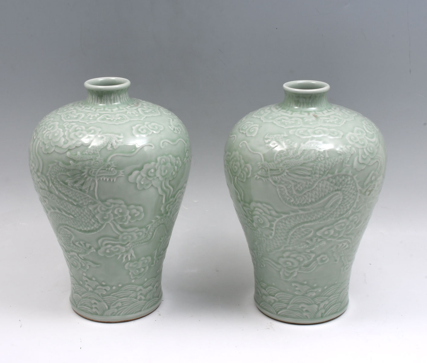 Appraisal: PAIR OF CHINESE CELADON GLAZED DRAGON VASES Chinese porcelain Meiping