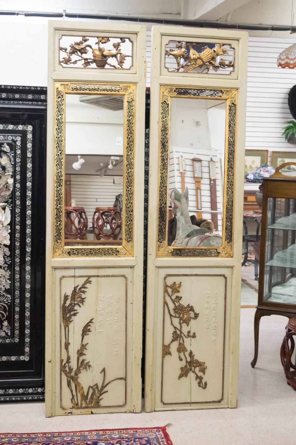 Appraisal: A PAIR OF CARVED GILDED AND PAINTED WOOD SCREEN PANELS