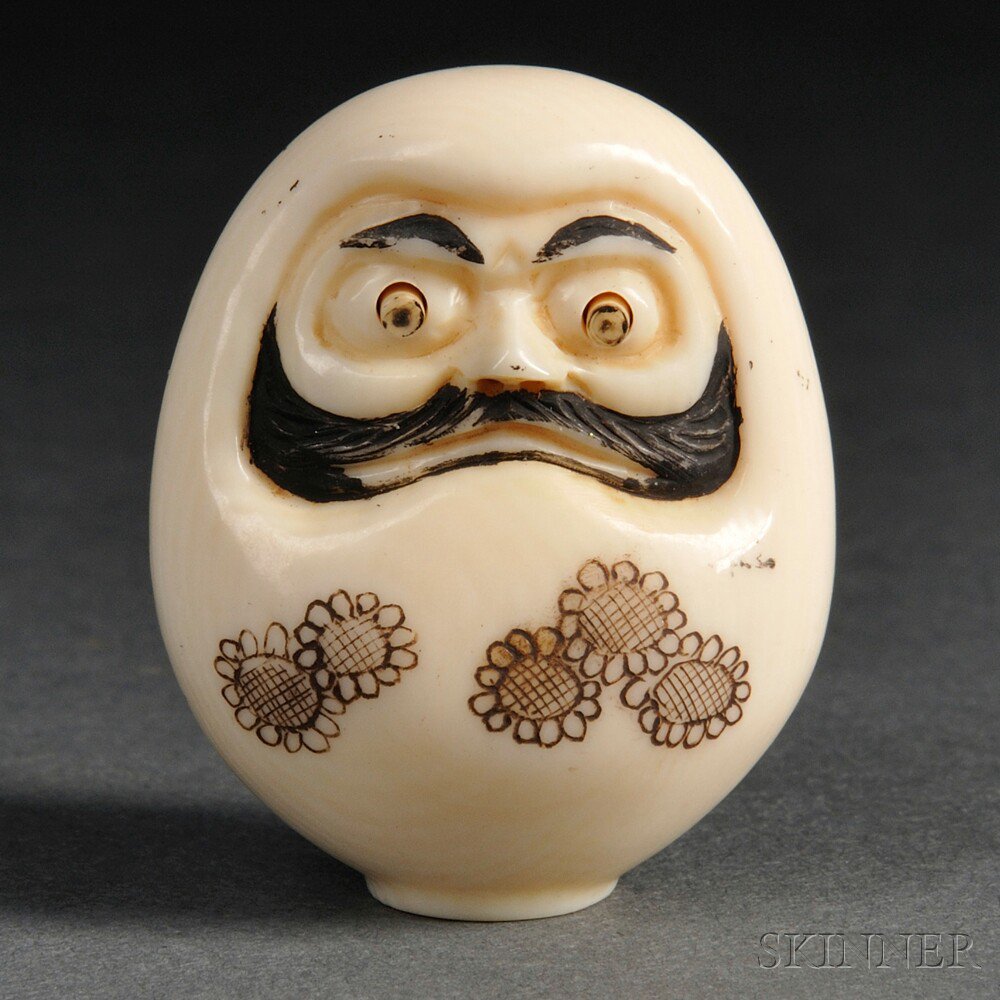 Appraisal: Ivory Netsuke of a Face Japan th century carved in