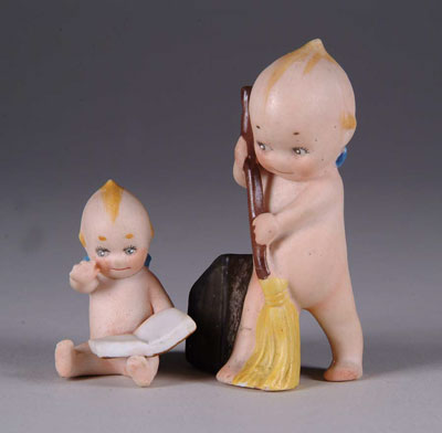 Appraisal: KEWPIE WITH BOOK AND KEWPIE SWEEPER and - respectively The