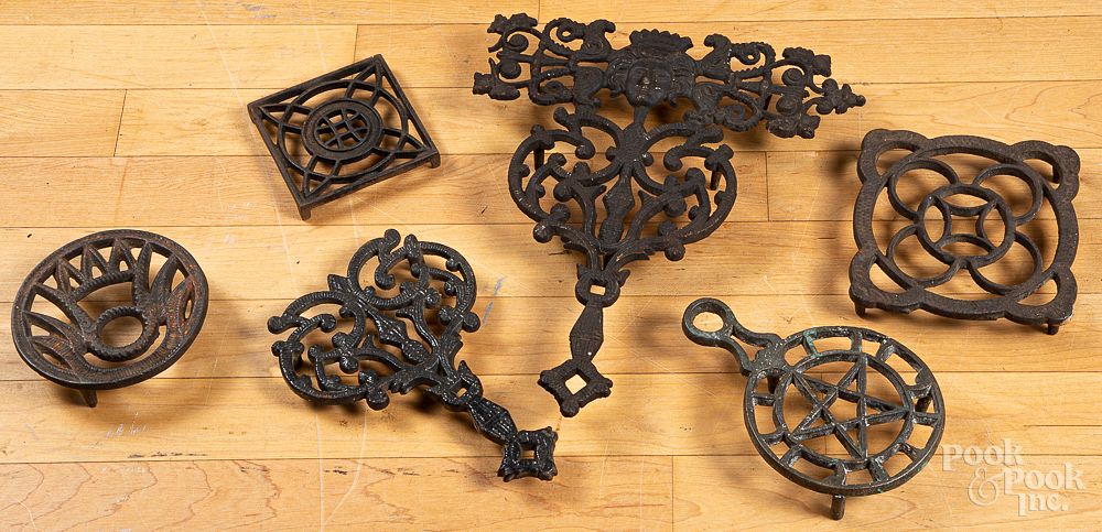 Appraisal: Six cast iron trivets Six cast iron trivets largest x