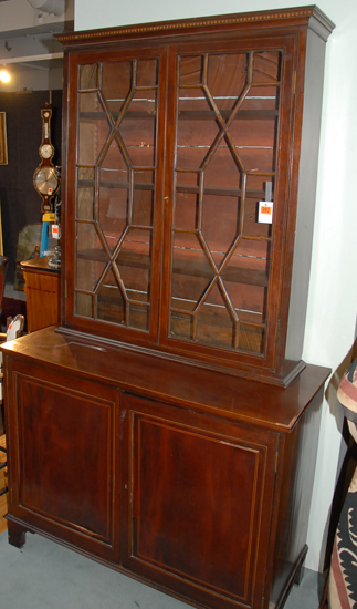 Appraisal: A Regency Stepback Bookcase Cupboard of mahogany with molded and