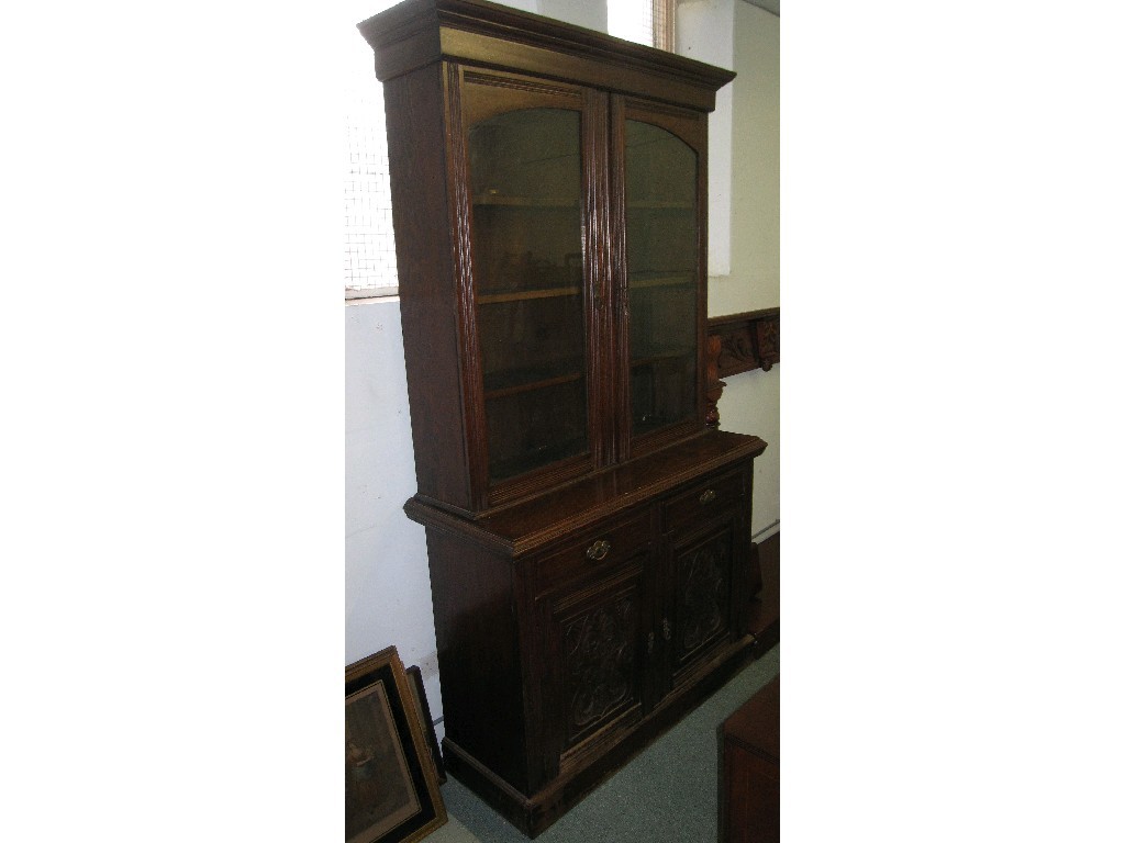 Appraisal: Late Victorian oak glazed door bookcase on cabinet