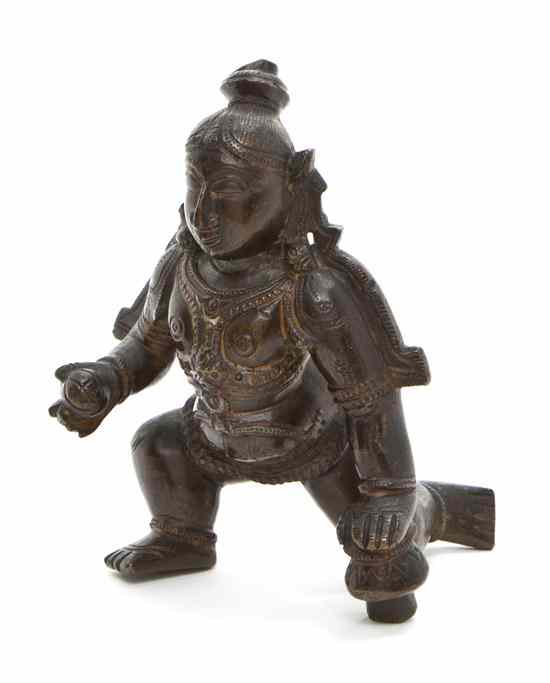 Appraisal: An Indian Bronze Figure of Krishna depicted in a striding