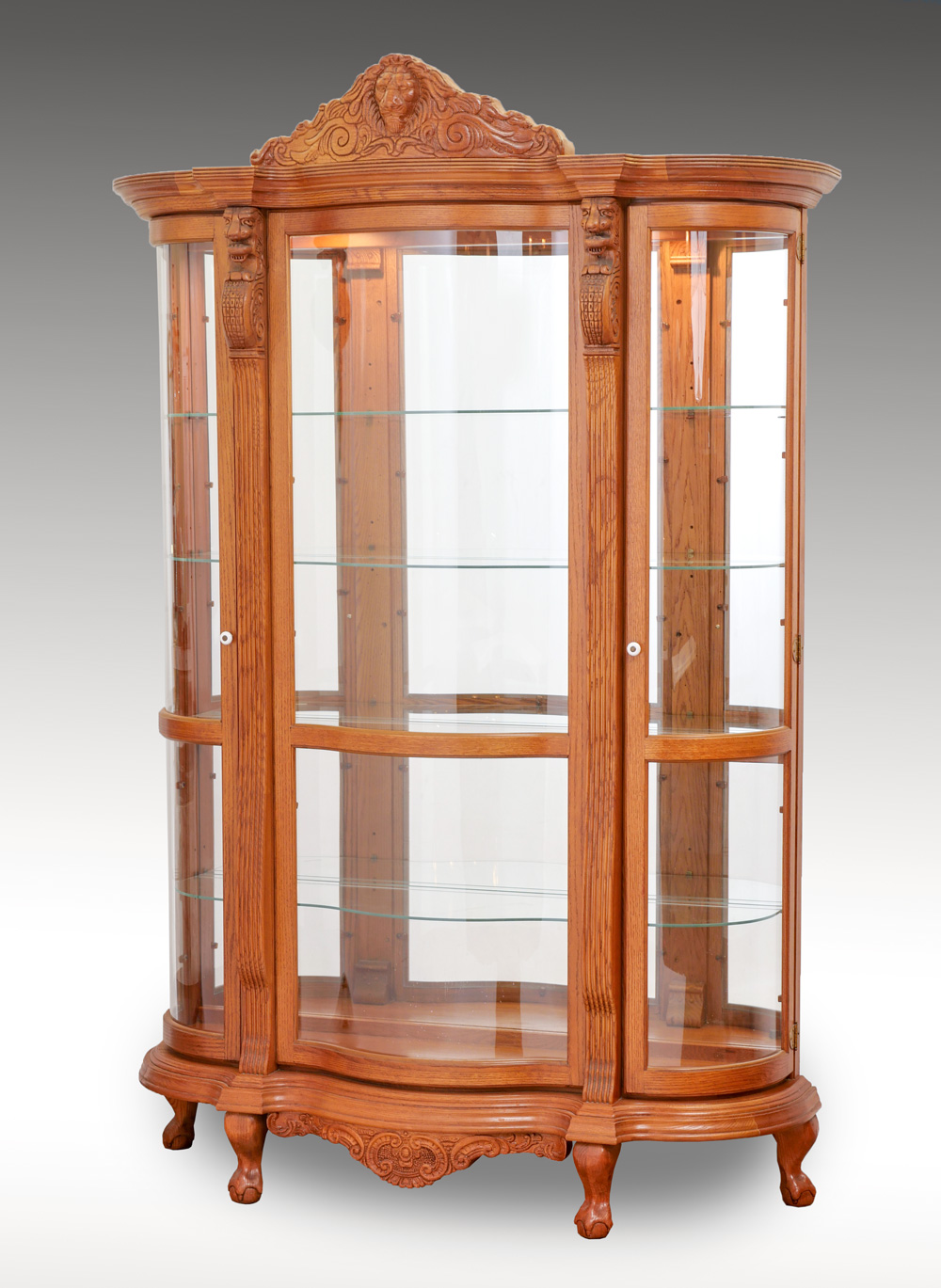 Appraisal: CARVED OAK TRIPLE BOW CURIO CABINET Oak triple bow curio